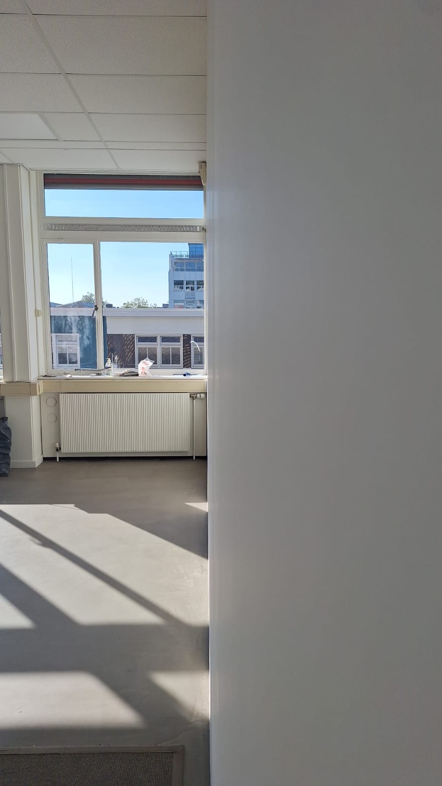 Geschilderde kantoorwand bij een raam in Schinkelhaven, Amsterdam
